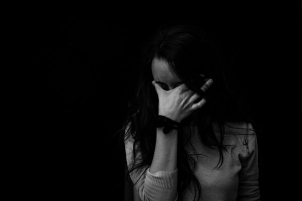 a anxious woman in black background